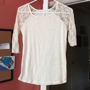 Off white shirt with lace quarter sleeves.